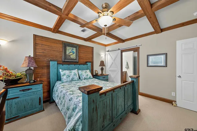 a bedroom with a bed a dresser and potted plants