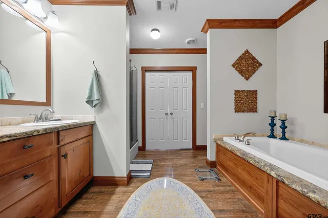 a spacious bathroom with a double vanity sink and a mirror