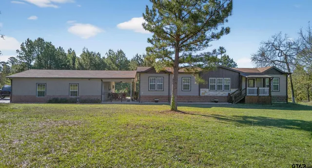 a front view of house with yard and green space