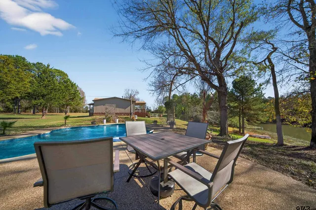 a view of a terrace with furniture and a yard
