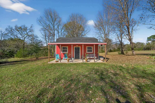 a view of house with backyard