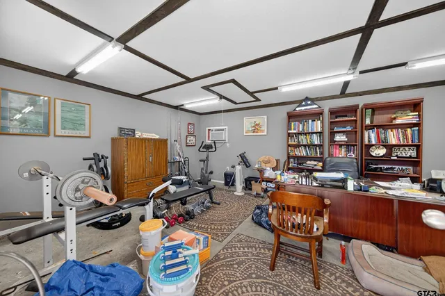 a work room with furniture and a flat screen tv