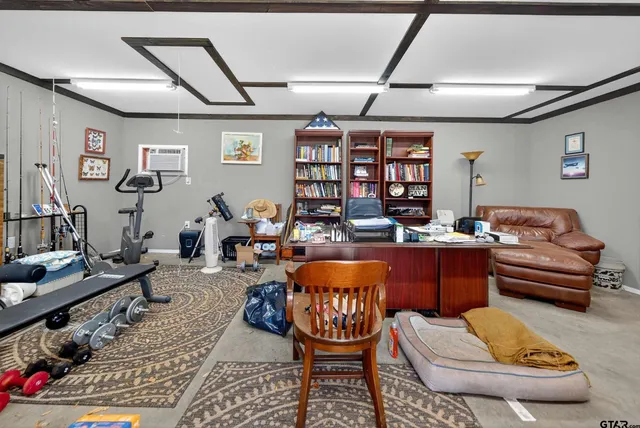 a living room with furniture and a bookshelf