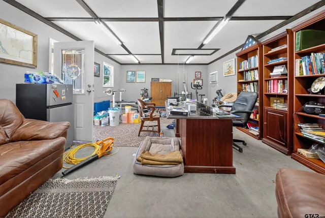 a living room with furniture and a book shelf