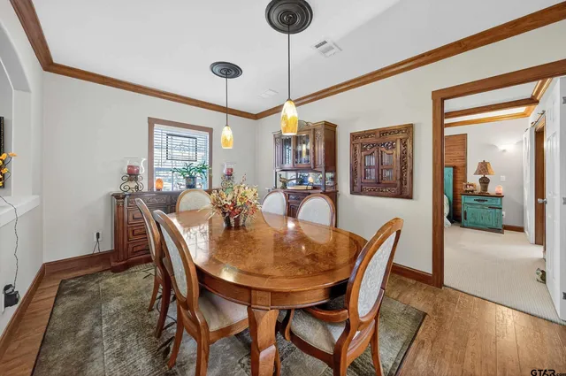 a view of a dining room with furniture and wooden floor