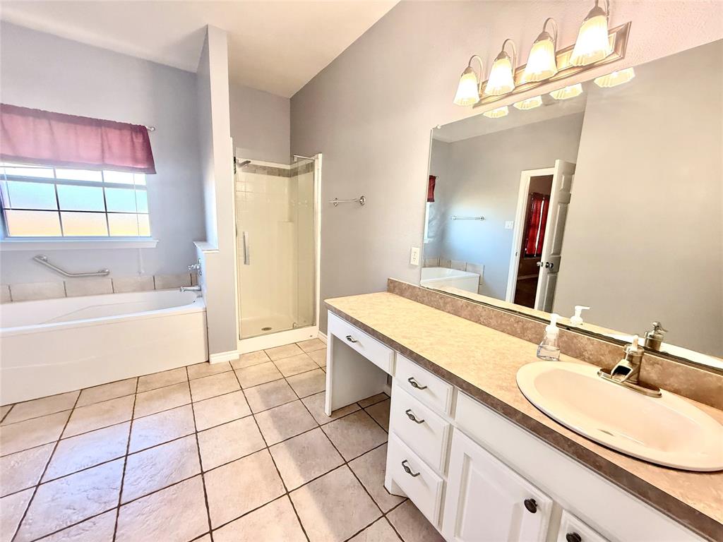 2429 Pecan Springs Road Cleburne, TX 76031 - Photo 13 of 21 a spacious bathroom with a tub sink and mirror