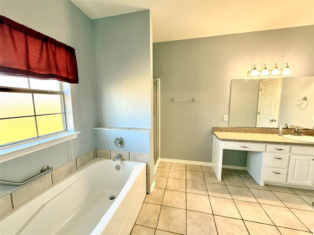 2429 Pecan Springs Road Cleburne, TX 76031 - Photo 14 of 21 a spacious bathroom with a tub sink and mirror