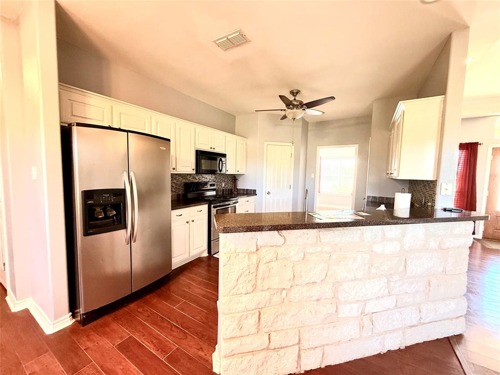 2429 Pecan Springs Road Cleburne, TX 76031 - Photo 20 of 21 a large kitchen with stainless steel appliances a refrigerator and a sink