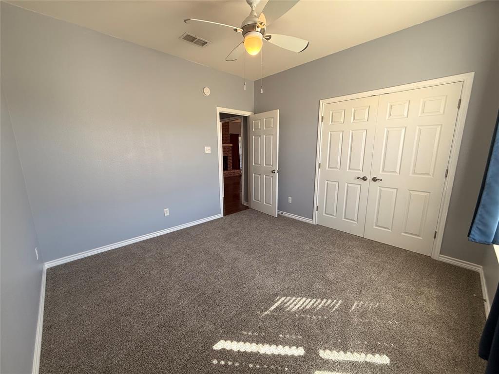 2429 Pecan Springs Road Cleburne, TX 76031 - Photo 6 of 21 an empty room with closet and a chandelier fan