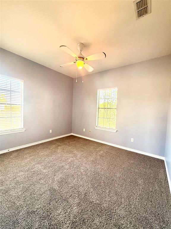 2429 Pecan Springs Road Cleburne, TX 76031 - Photo 10 of 21 an empty room with a window and a ceiling fan