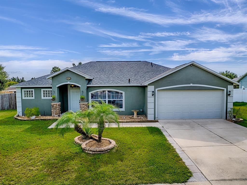 a front view of a house with a yard and garage