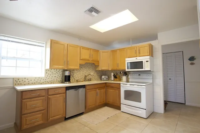a kitchen with a sink stove and refrigerator