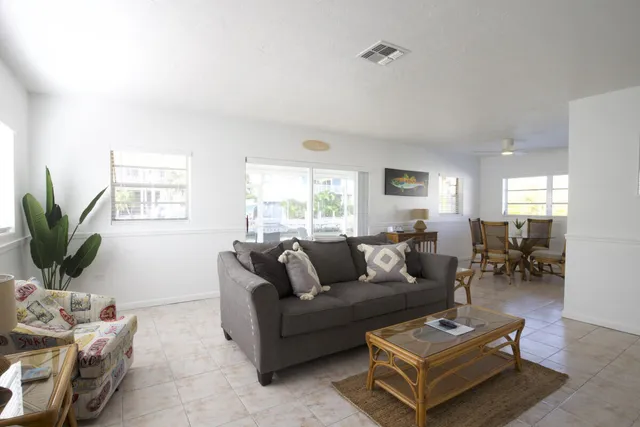 a living room with furniture a wooden floor and a flat screen tv