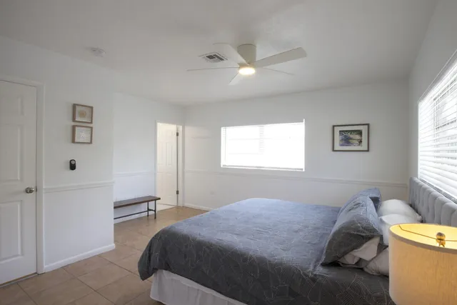 a bedroom with a bed and a window