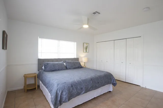 a bedroom with a large bed and a window