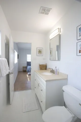 a bathroom with a toilet sink and mirror