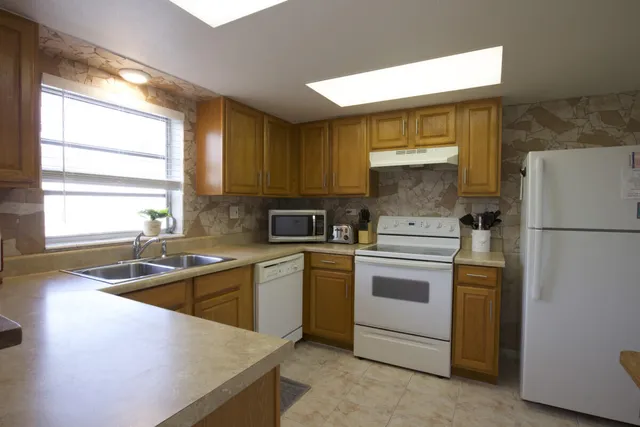 a kitchen with a refrigerator stove and sink