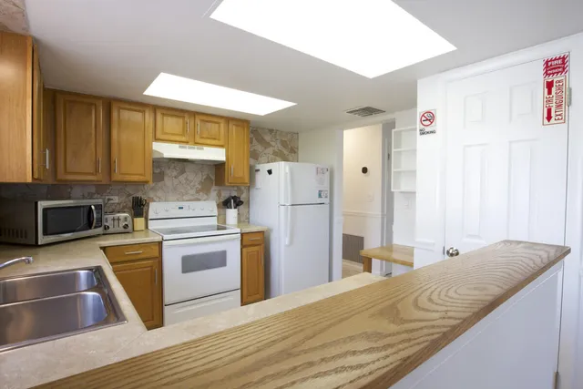 a kitchen with a refrigerator a stove top oven a sink and dishwasher