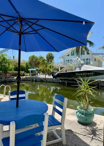 a patio with wooden table and chairs