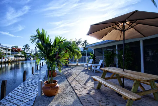 a view of a patio with table and chairs under an umbrella