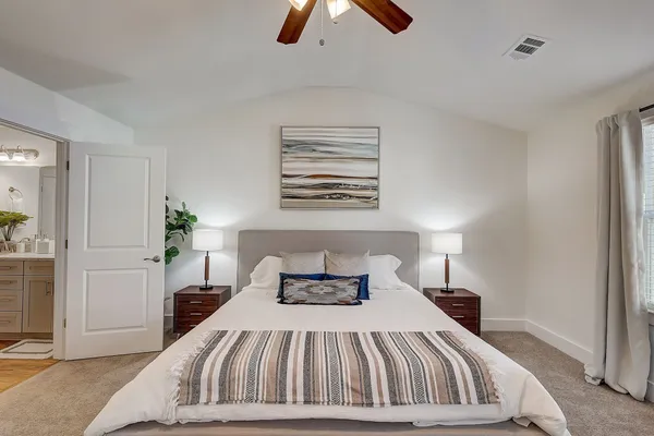 a bedroom with a bed and window