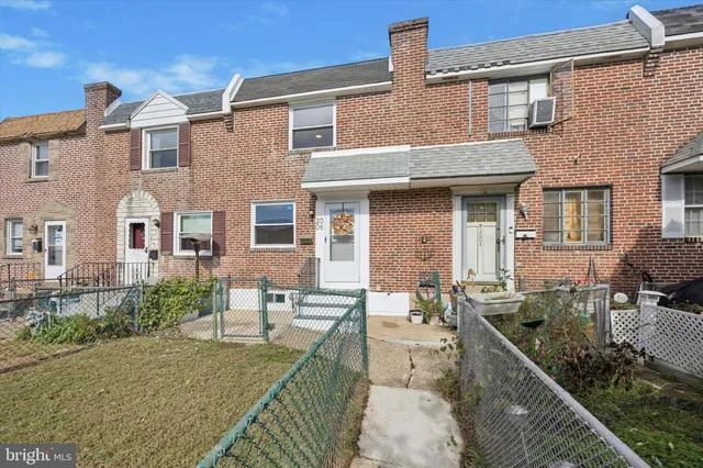 a front view of house with yard outdoor seating and barbeque oven