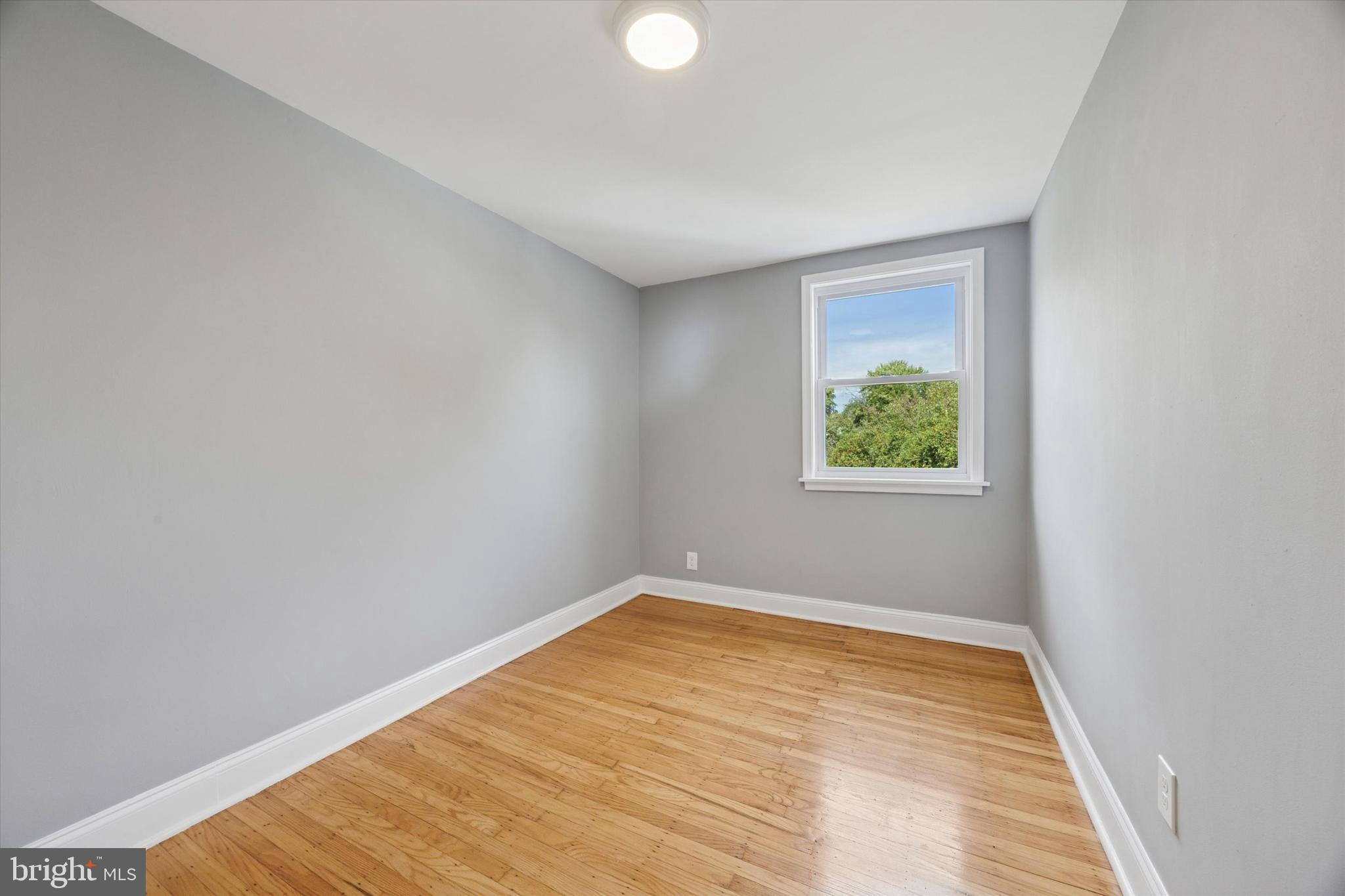 2006 Carter Road Folcroft, PA 19032 - Photo 13 of 25 a view of an empty room with wooden floor and a window
