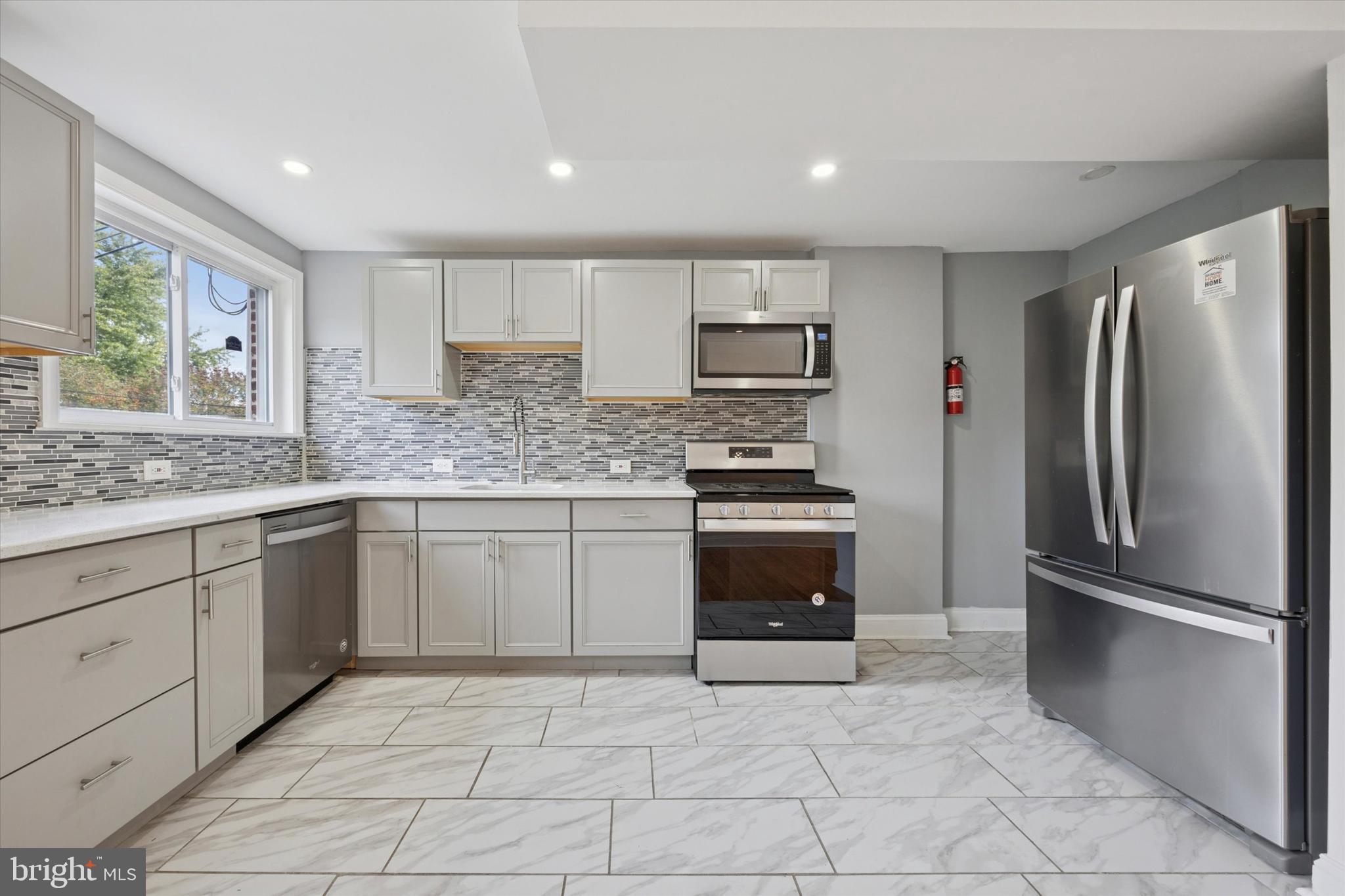 2006 Carter Road Folcroft, PA 19032 - Photo 4 of 25 a kitchen with stainless steel appliances granite countertop a refrigerator sink and stove