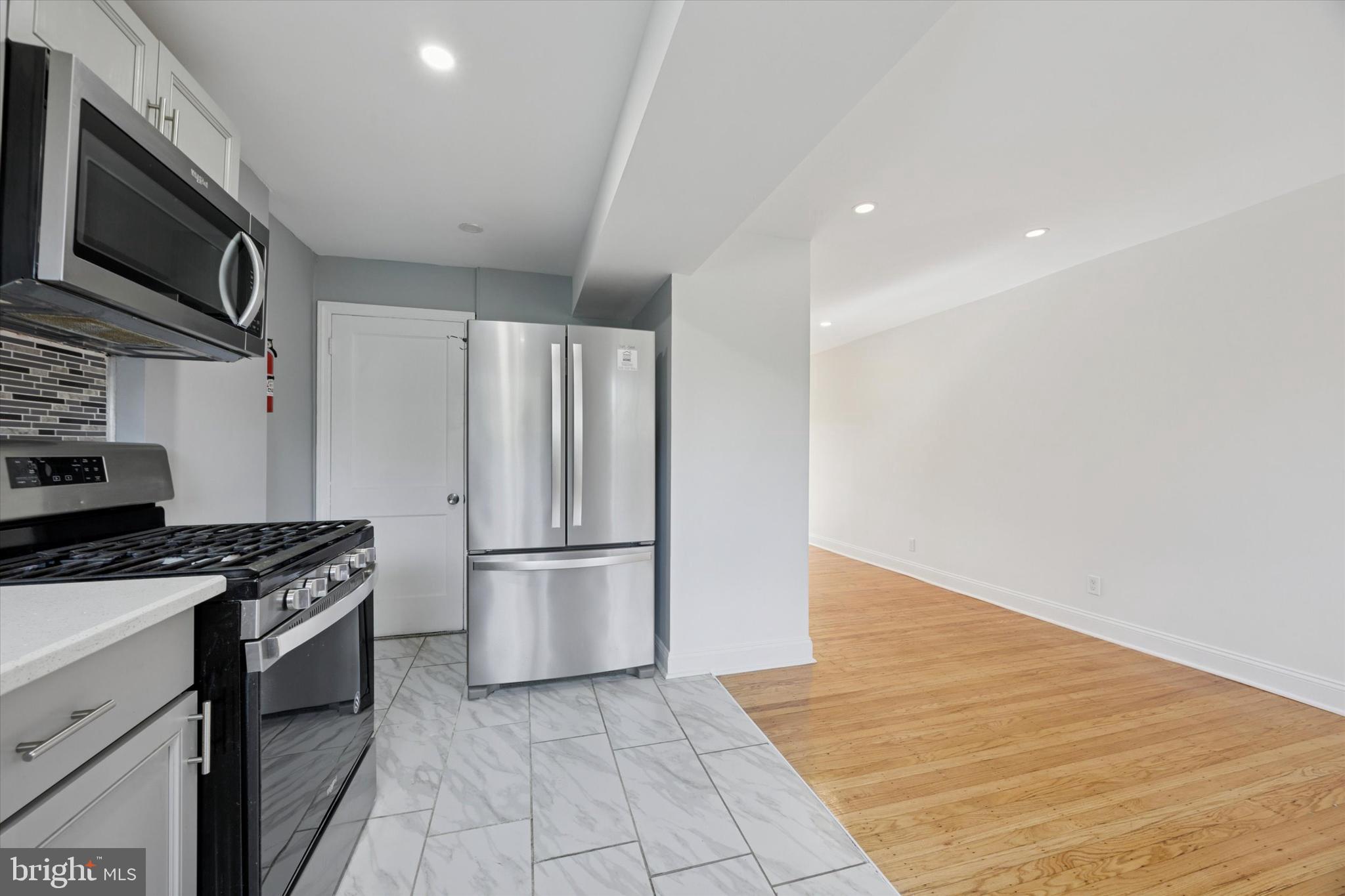 2006 Carter Road Folcroft, PA 19032 - Photo 6 of 25 a kitchen with granite countertop a refrigerator and a stove top oven