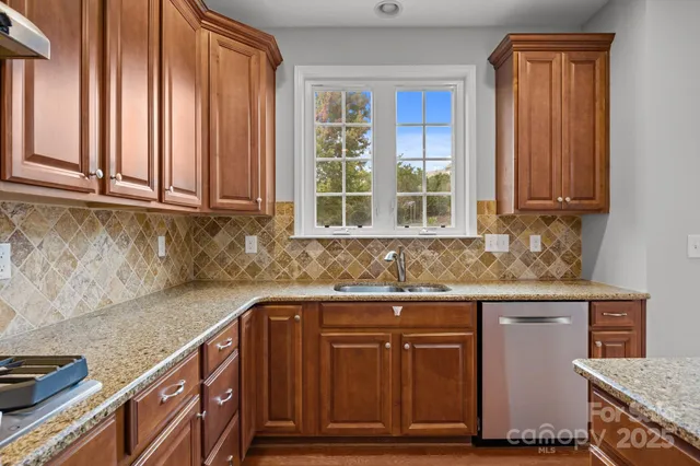 a kitchen with granite countertop cabinets and window