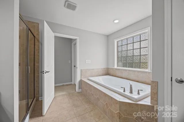 a bathroom with a bathtub and a shower