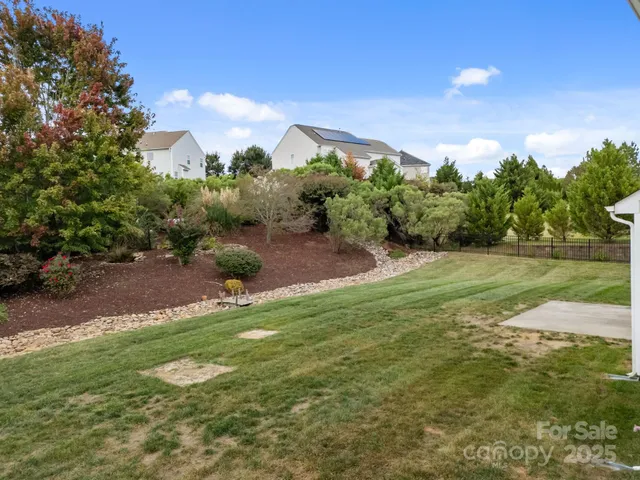 a view of a grassy field with trees around