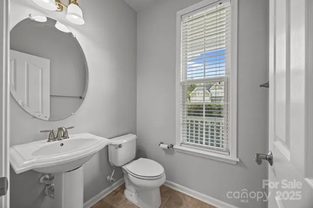 a bathroom with a sink toilet and a mirror