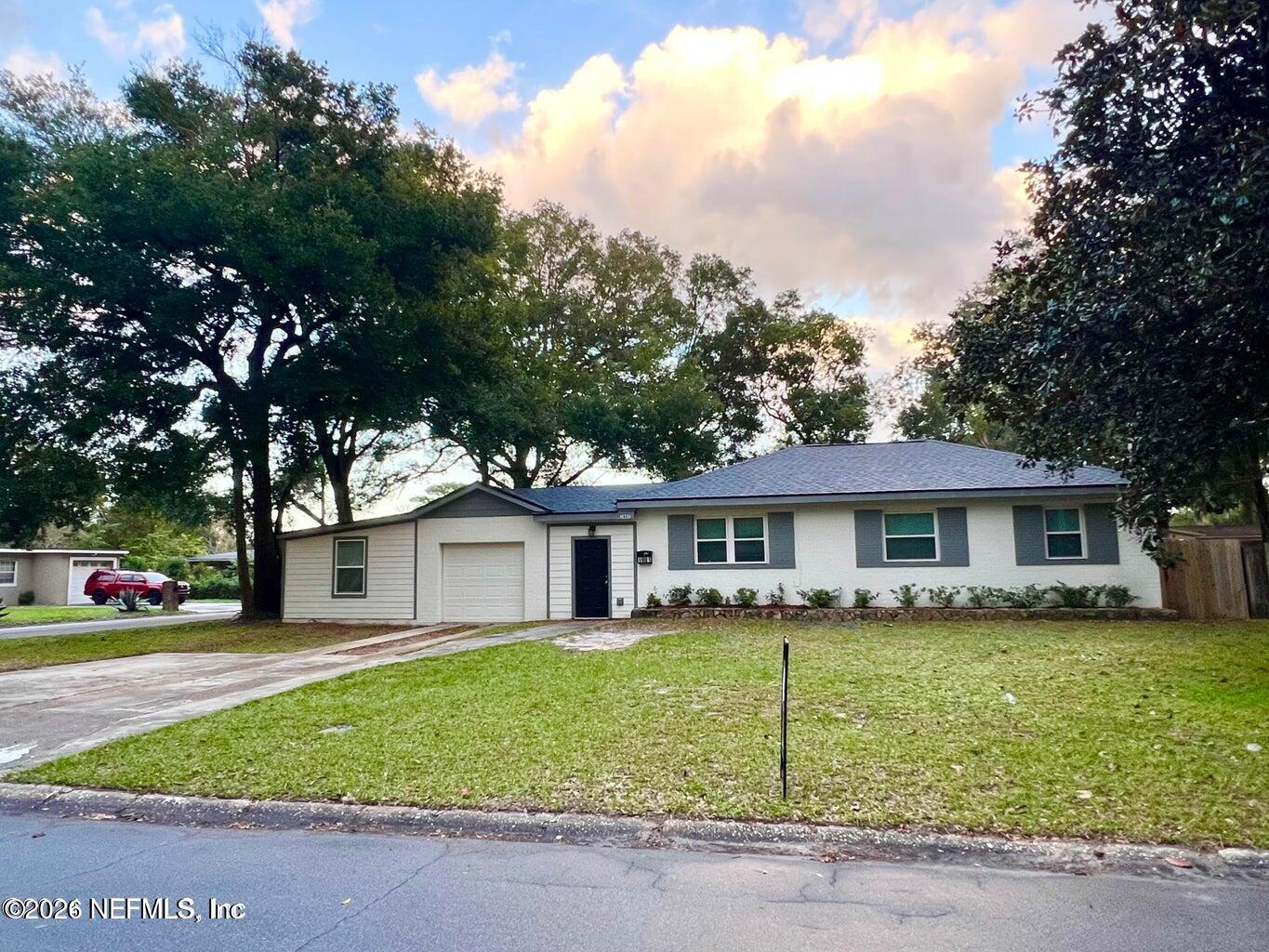 a view of a house with a yard