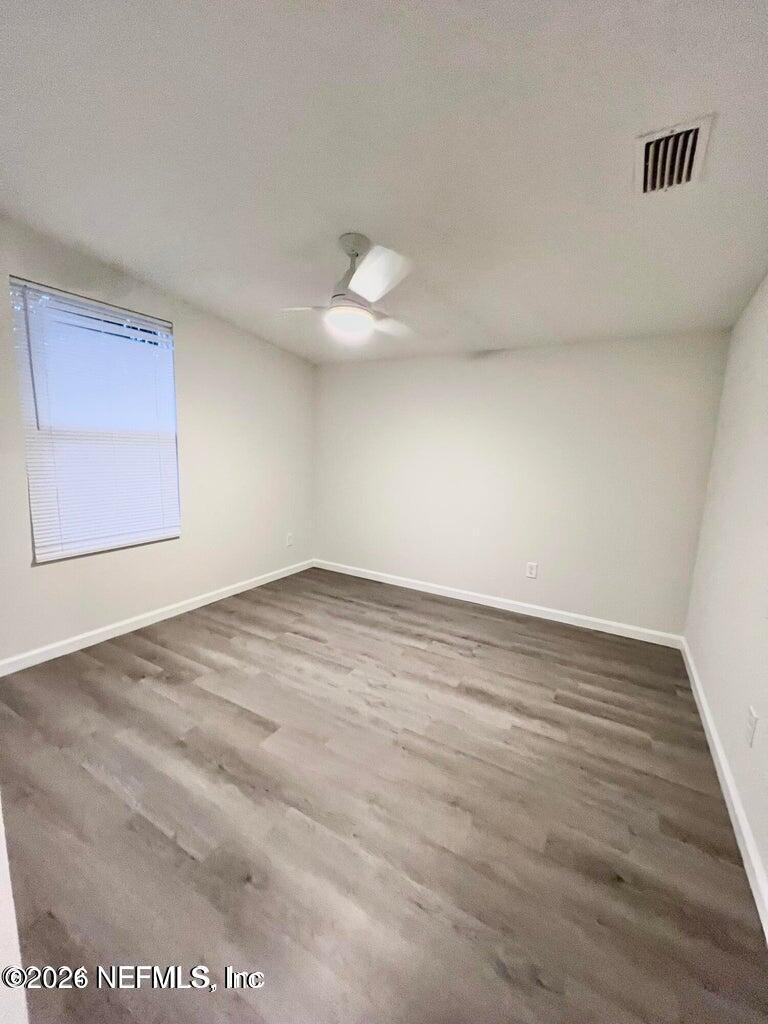 1961 New Haven Road Jacksonville, FL 32211 - Photo 15 of 53 an empty room with wooden floor and windows