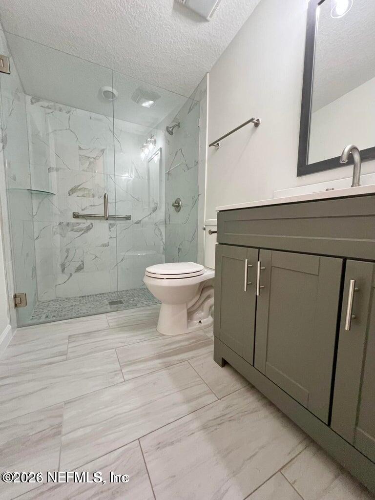 1961 New Haven Road Jacksonville, FL 32211 - Photo 17 of 53 a bathroom with a toilet a sink and shower