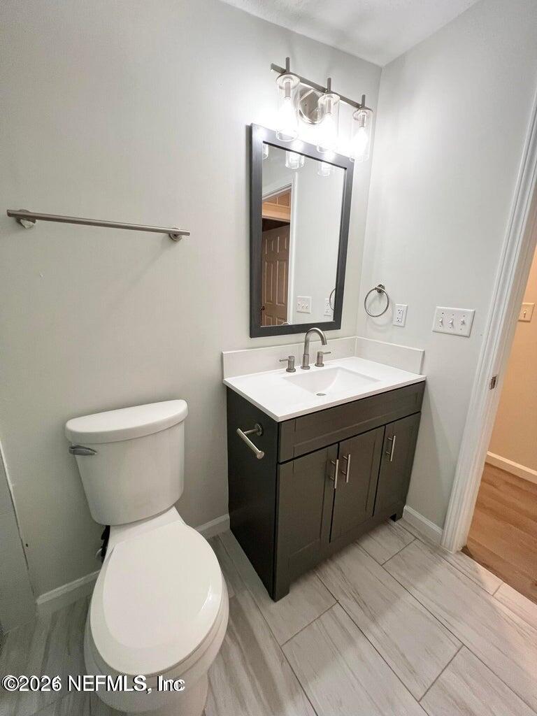 1961 New Haven Road Jacksonville, FL 32211 - Photo 18 of 53 a bathroom with a toilet sink and mirror