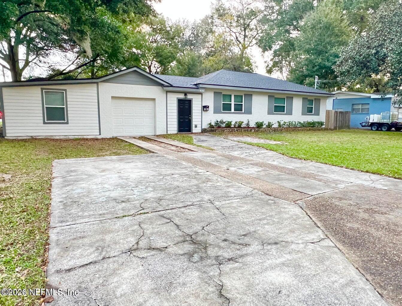 1961 New Haven Road Jacksonville, FL 32211 - Photo 2 of 53 a view of a yard in front of a house with a large tree