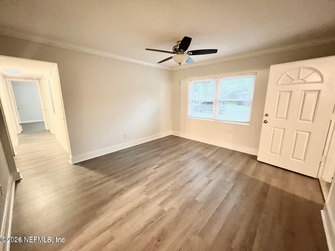 1961 New Haven Road Jacksonville, FL 32211 - Photo 27 of 53 a view of empty room with wooden floor and fan