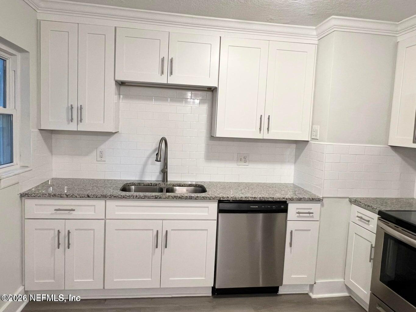 1961 New Haven Road Jacksonville, FL 32211 - Photo 29 of 53 a kitchen with granite countertop white cabinets and a stove