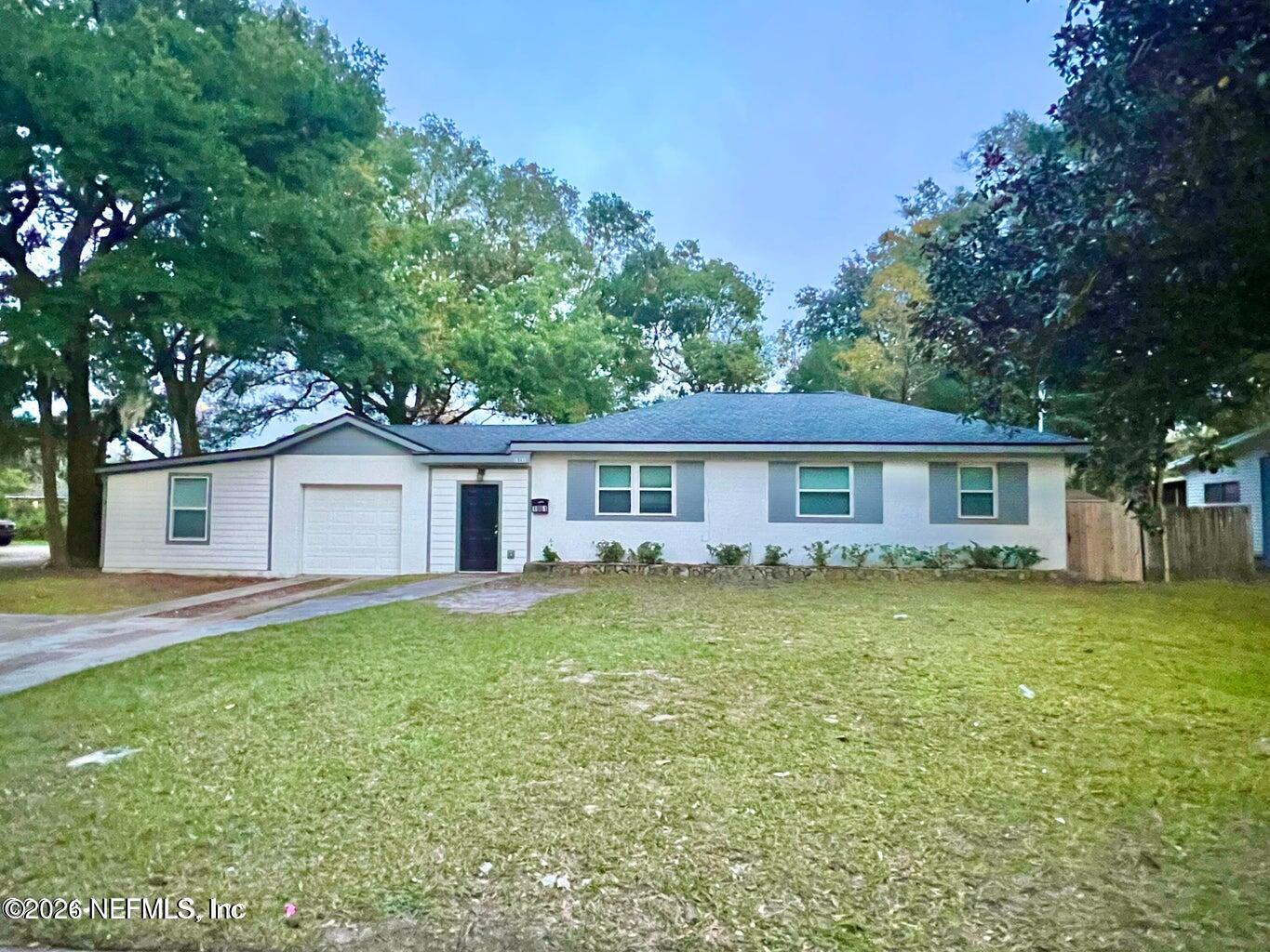 1961 New Haven Road Jacksonville, FL 32211 - Photo 3 of 53 a front view of a house with a garden