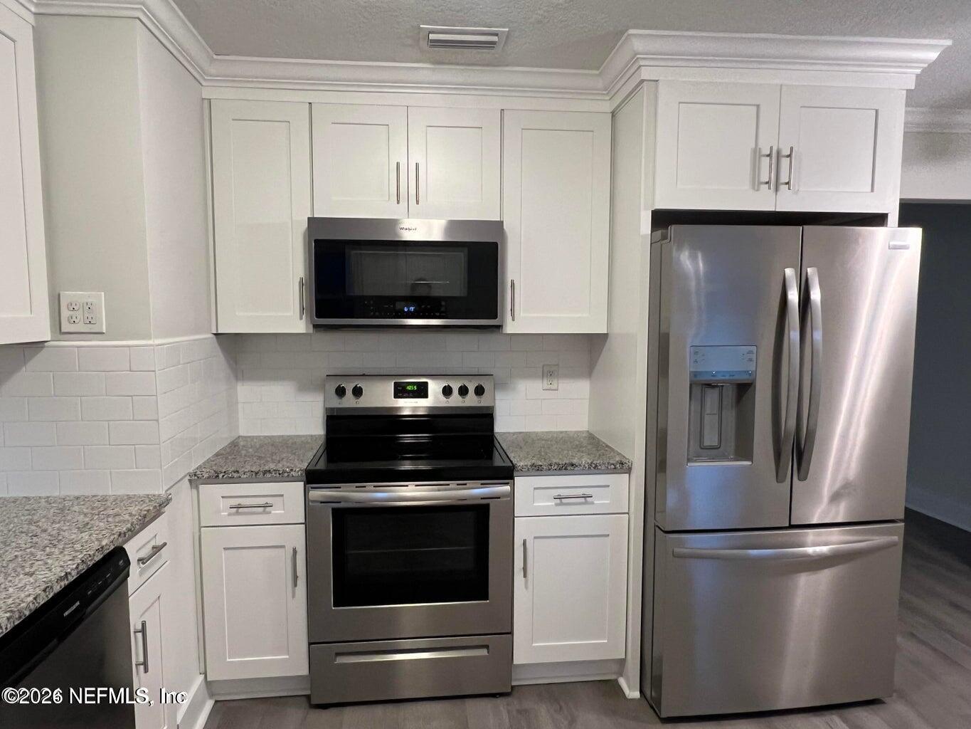 1961 New Haven Road Jacksonville, FL 32211 - Photo 31 of 53 a kitchen with a stove microwave and refrigerator
