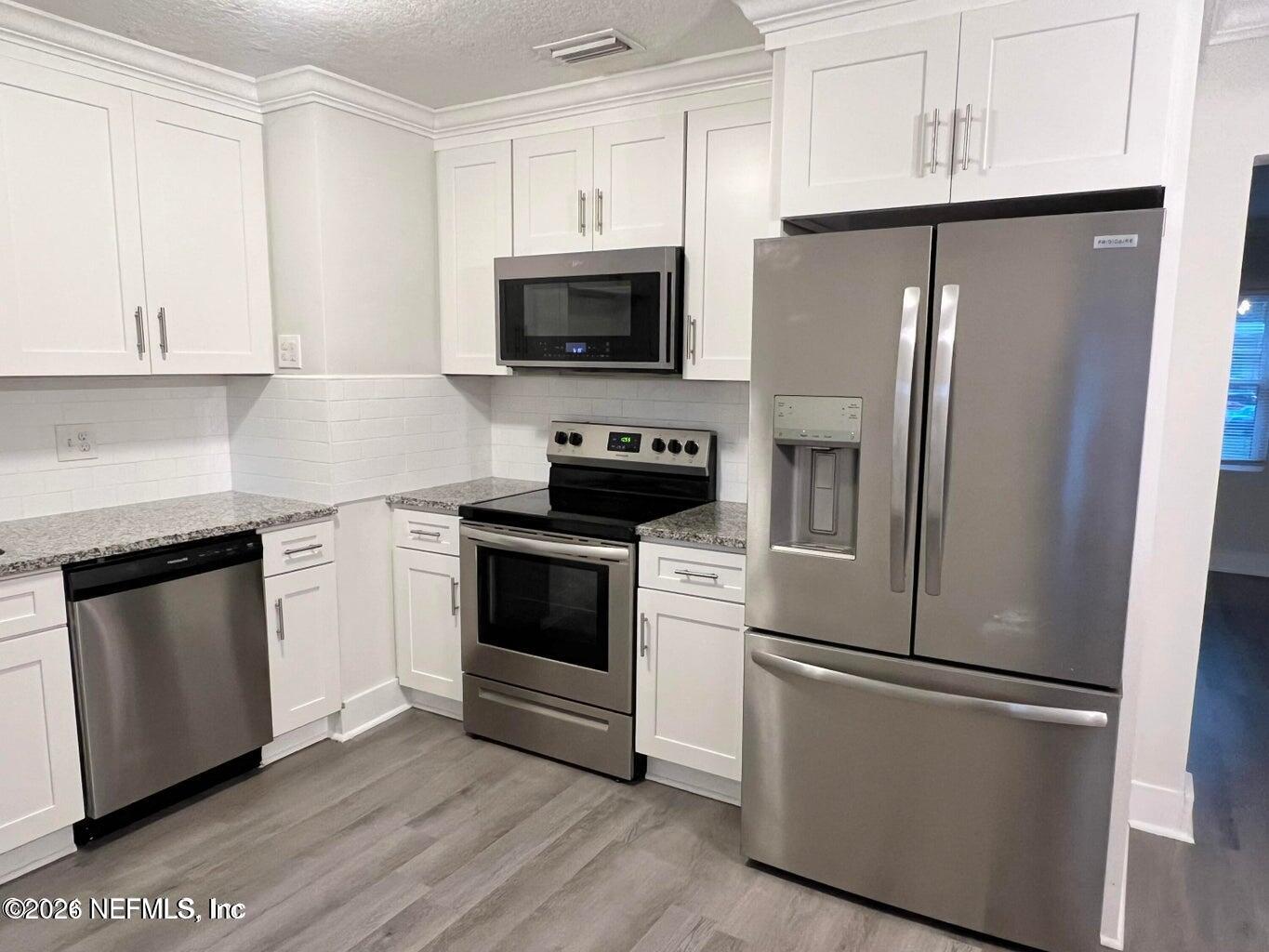 1961 New Haven Road Jacksonville, FL 32211 - Photo 32 of 53 a kitchen with stainless steel appliances a refrigerator stove and microwave