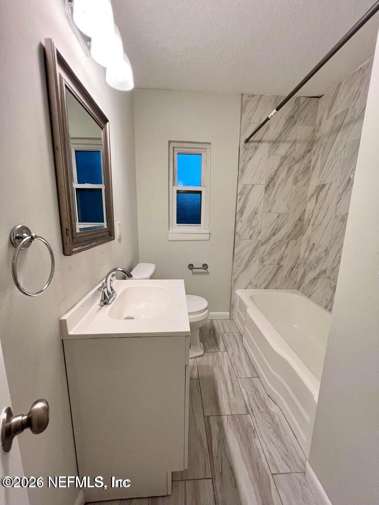 1961 New Haven Road Jacksonville, FL 32211 - Photo 34 of 53 a bathroom with a sink a toilet a mirror and shower