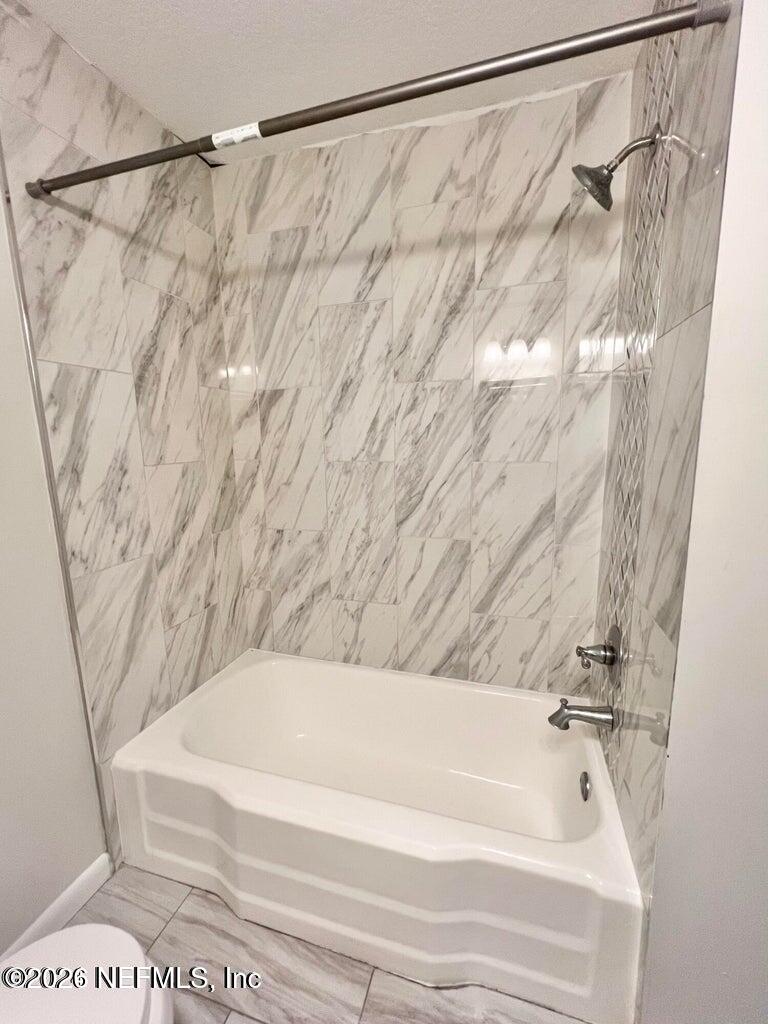 1961 New Haven Road Jacksonville, FL 32211 - Photo 35 of 53 a bathroom with a bathtub and shower