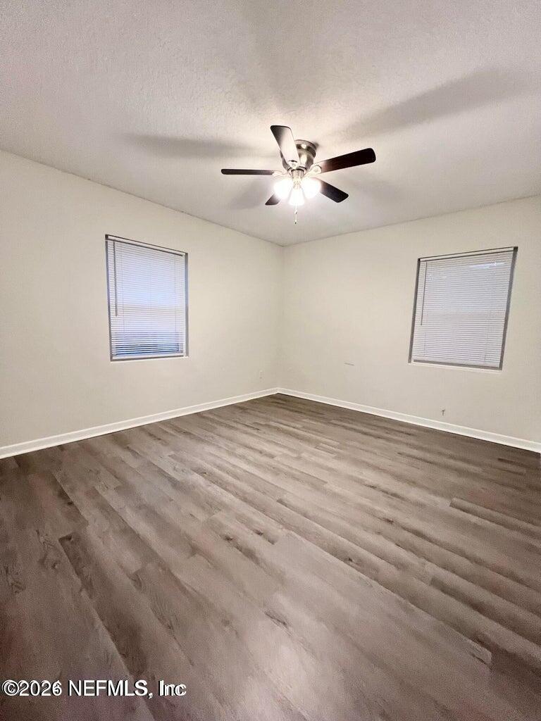 1961 New Haven Road Jacksonville, FL 32211 - Photo 37 of 53 a view of an empty room with wooden floor and a ceiling fan