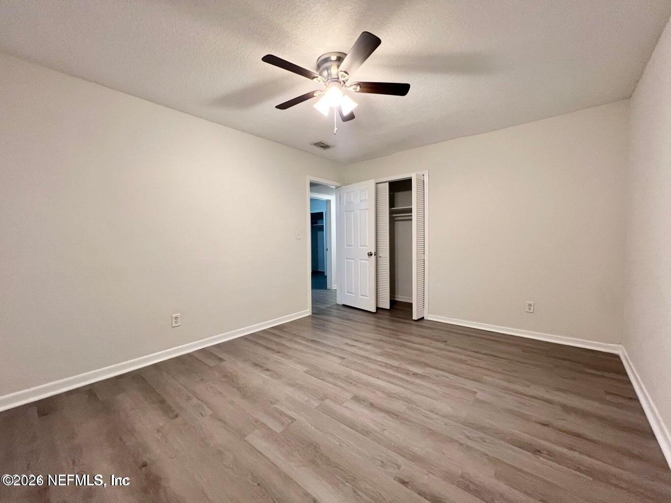 1961 New Haven Road Jacksonville, FL 32211 - Photo 38 of 53 an empty room with wooden floor and ceiling fan