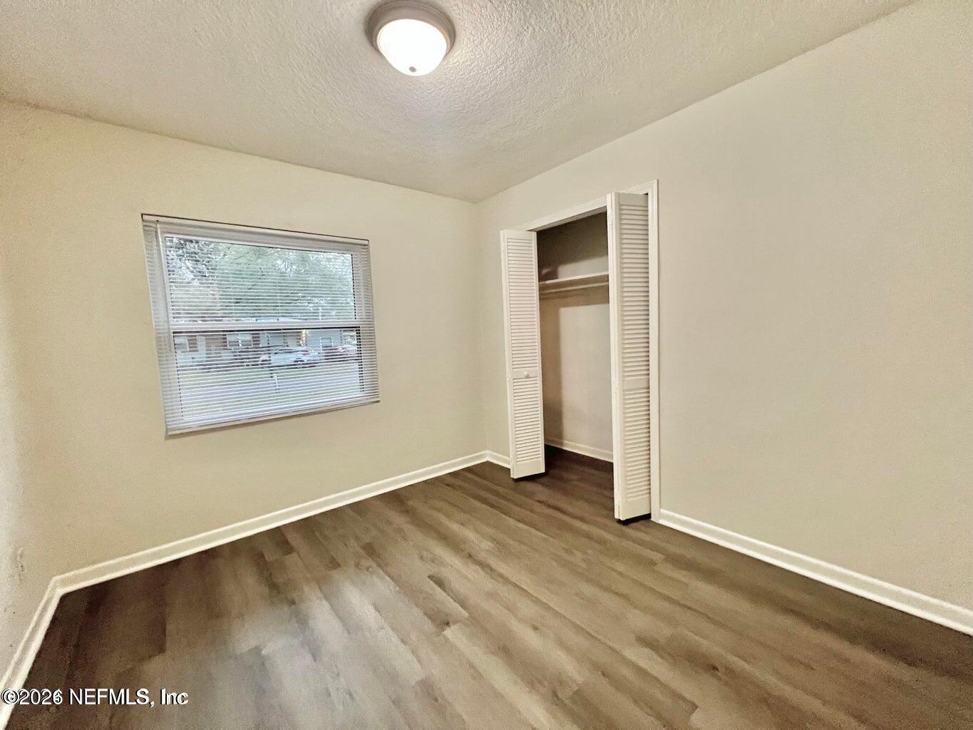 1961 New Haven Road Jacksonville, FL 32211 - Photo 42 of 53 an empty room with wooden floor and windows