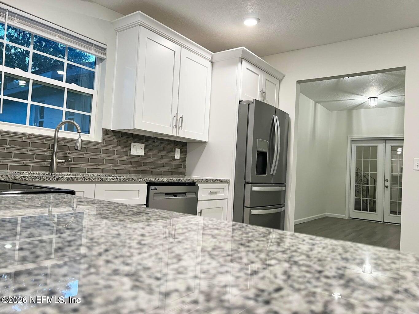 1961 New Haven Road Jacksonville, FL 32211 - Photo 8 of 53 a kitchen with stainless steel appliances granite countertop a refrigerator and a sink