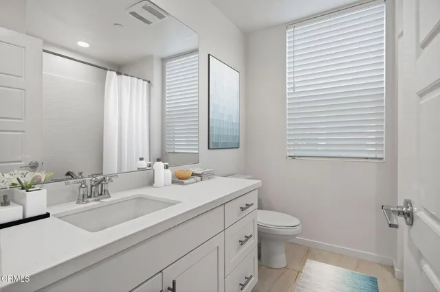 a view of a dining room with furniture and a chandelier